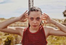 Woman Showering wearing red and black striped top